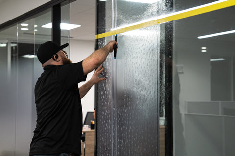 Commercial frost window film being applied to office windows Frederick, Md